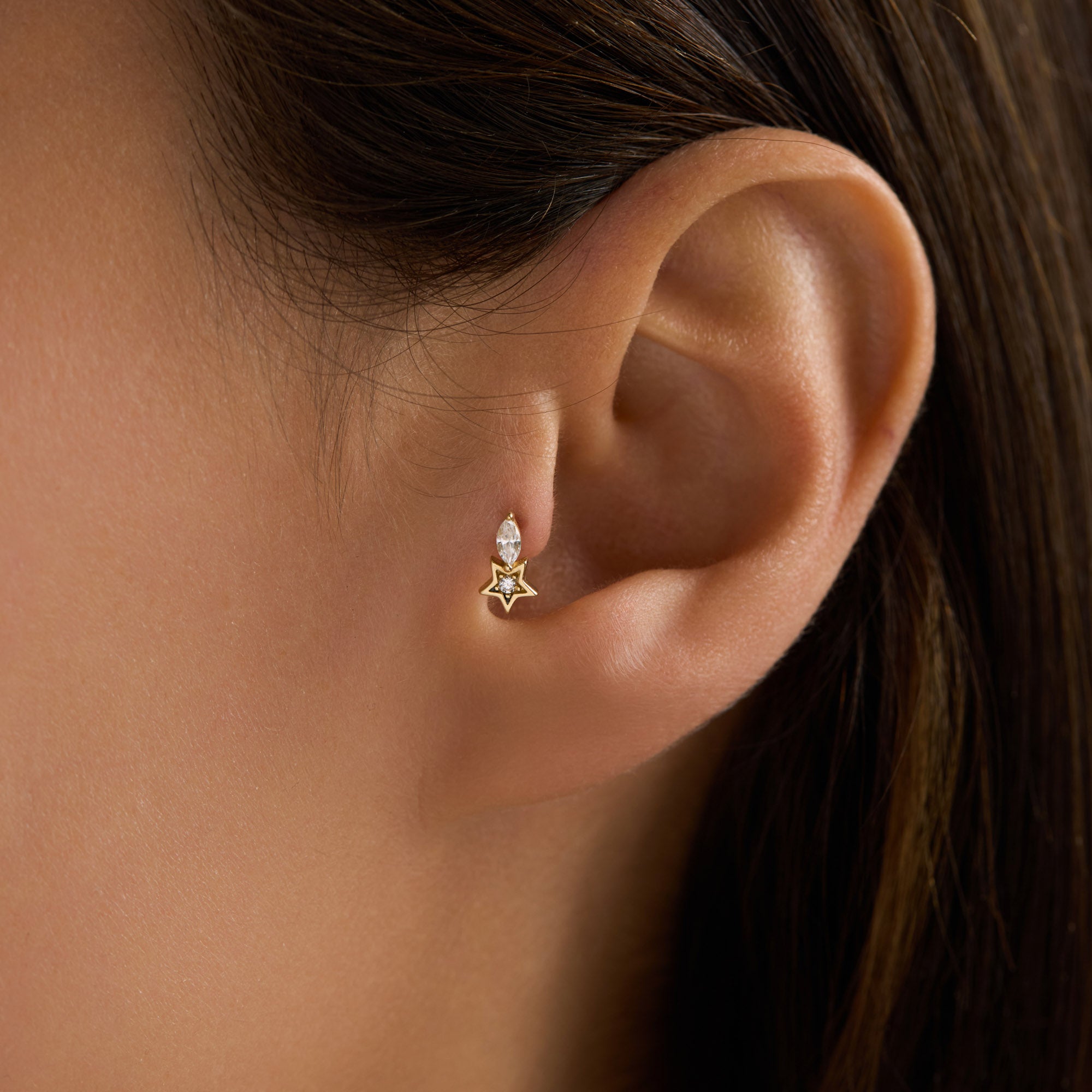Close-up of an ear wearing a star-shaped piercing