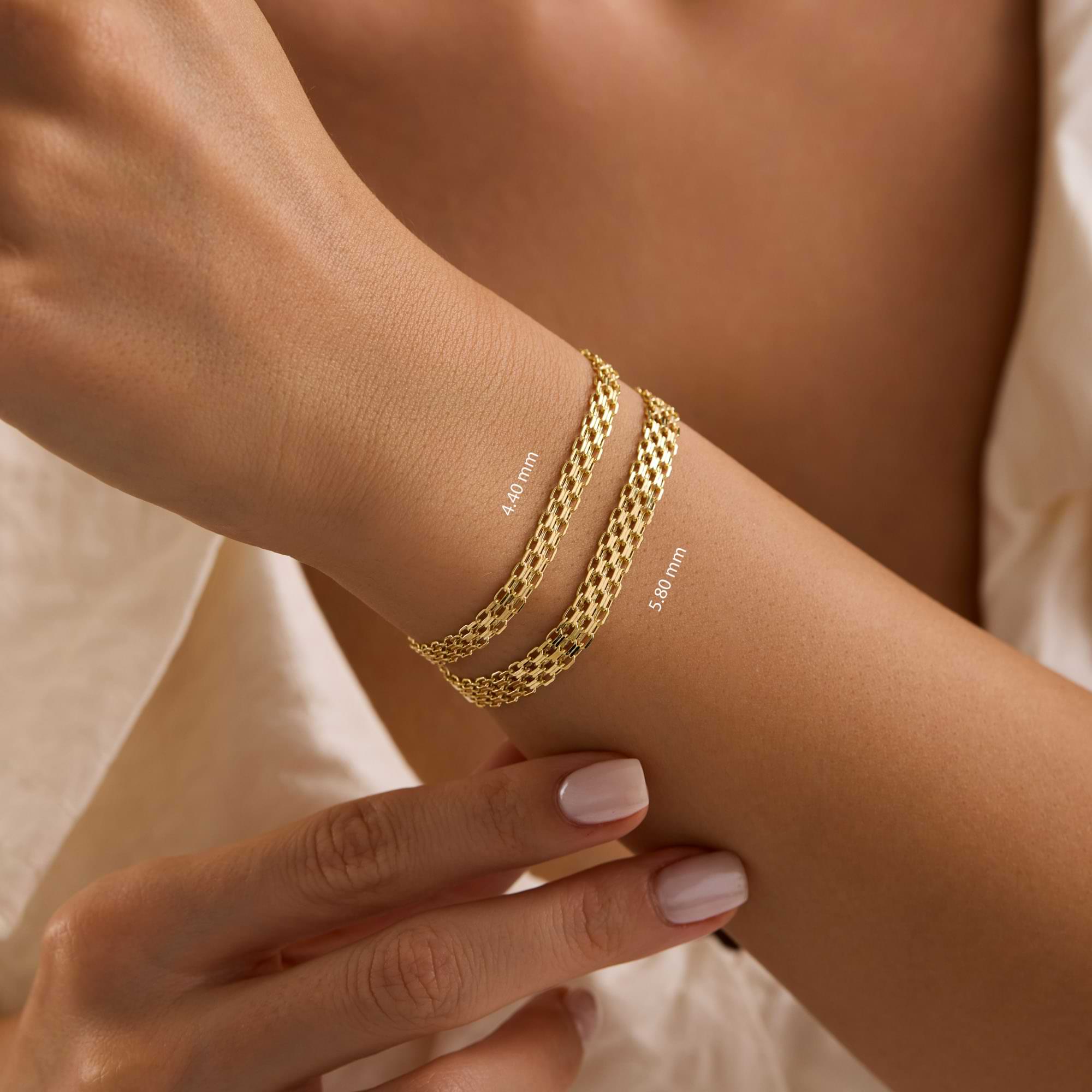 Gold bismarck chain bracelets on a wrist with close-up width measurements