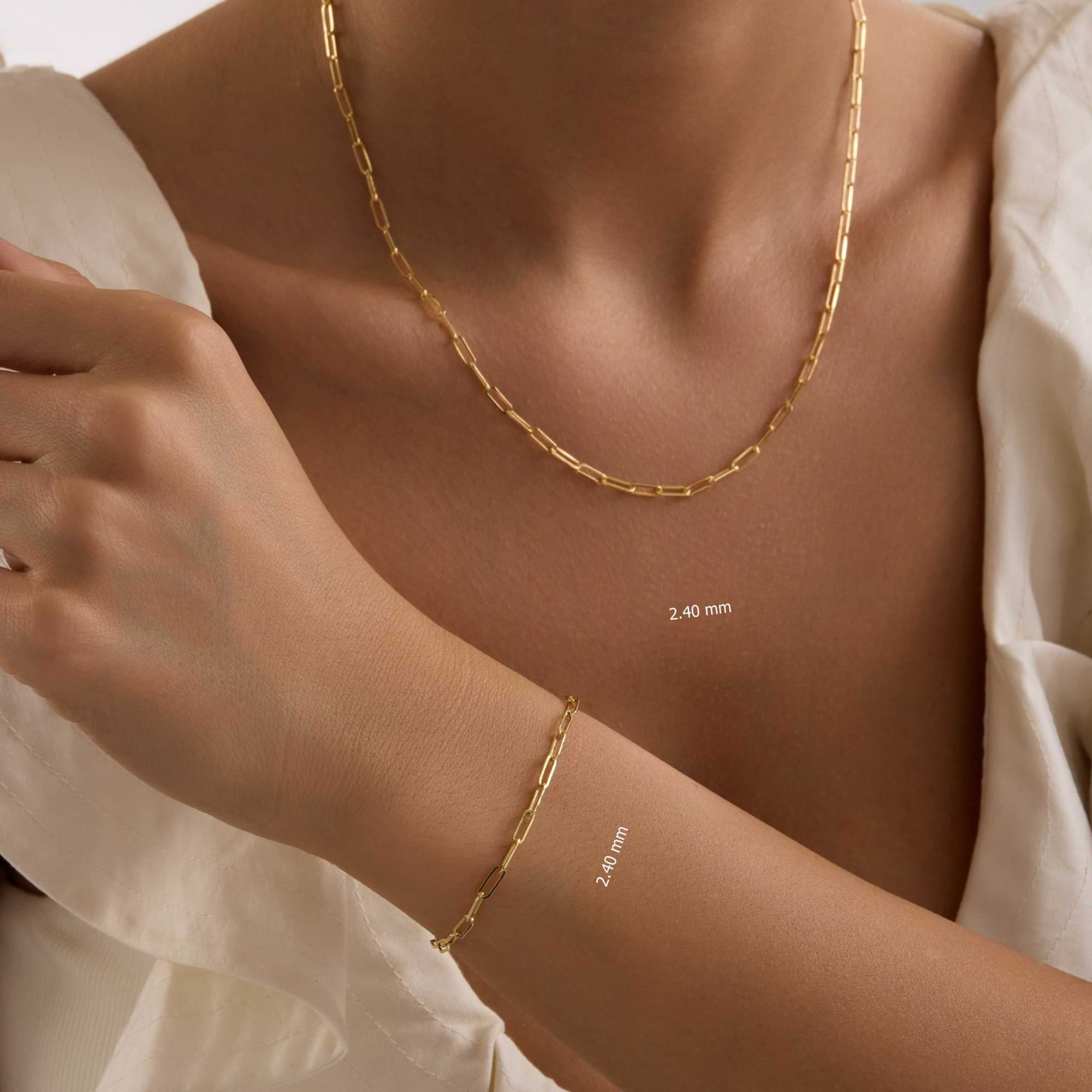 14k Gold 2.4mm Paperclip necklace and bracelet on a person's neck and wrist.