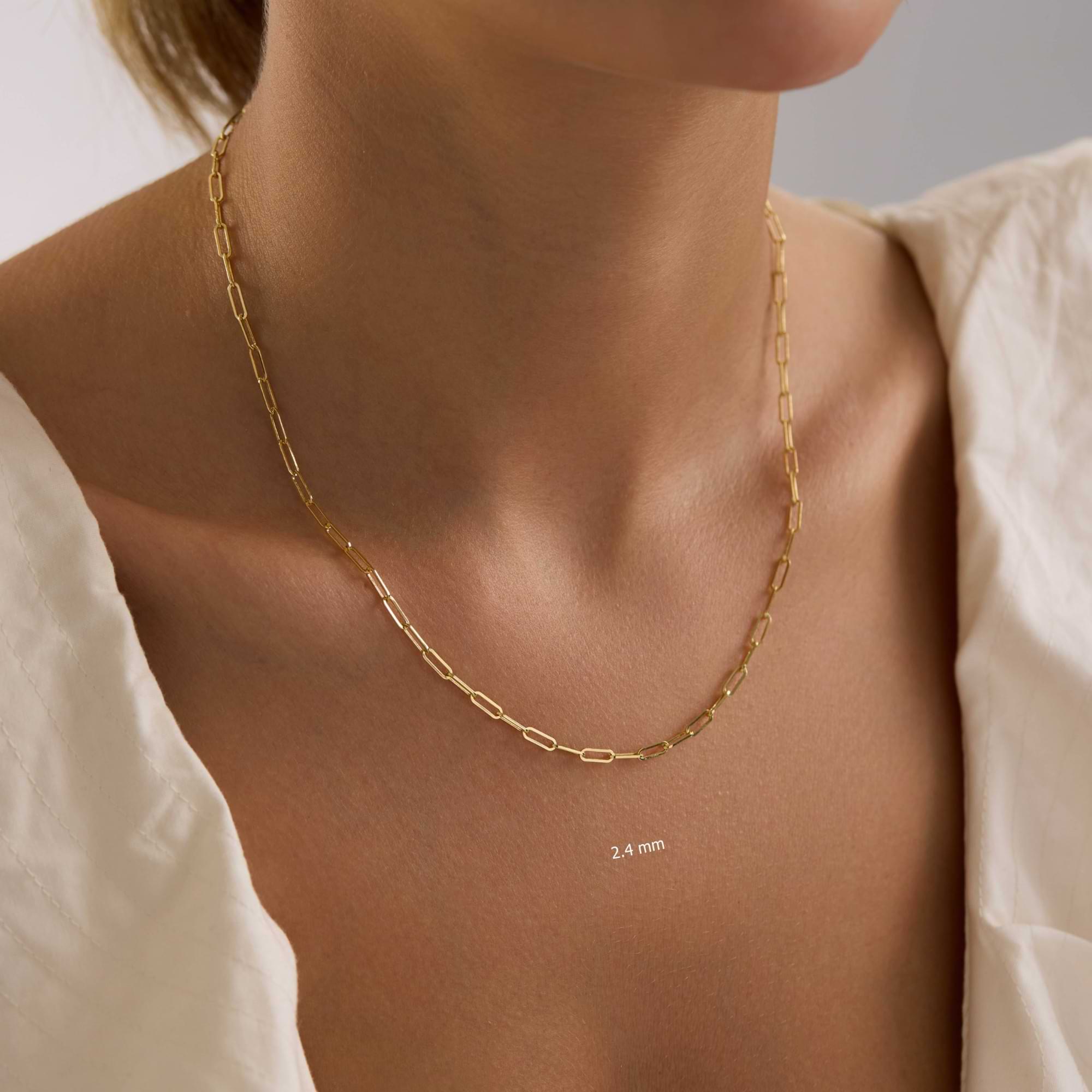 14K Gold 2.4mm Paperclip chain necklace on a person.