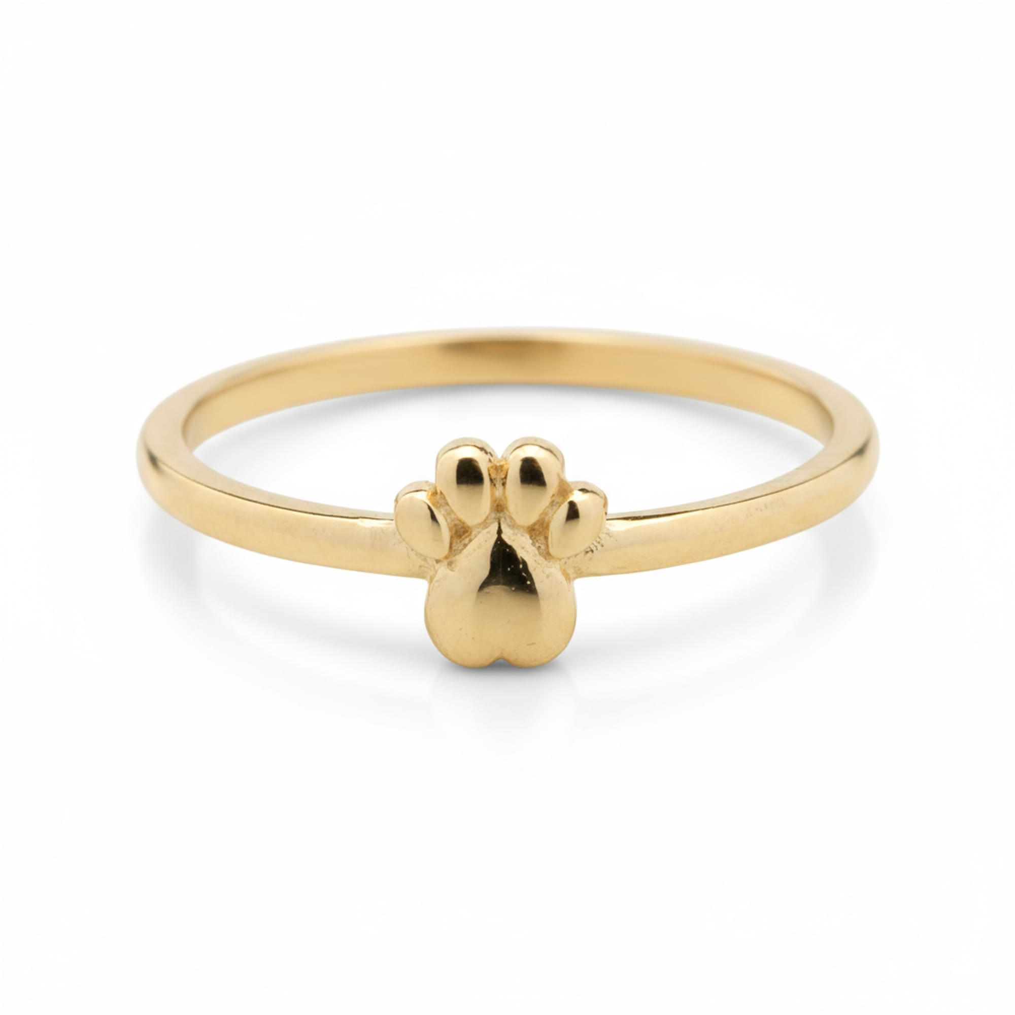 Gold ring with a paw print design on a white background