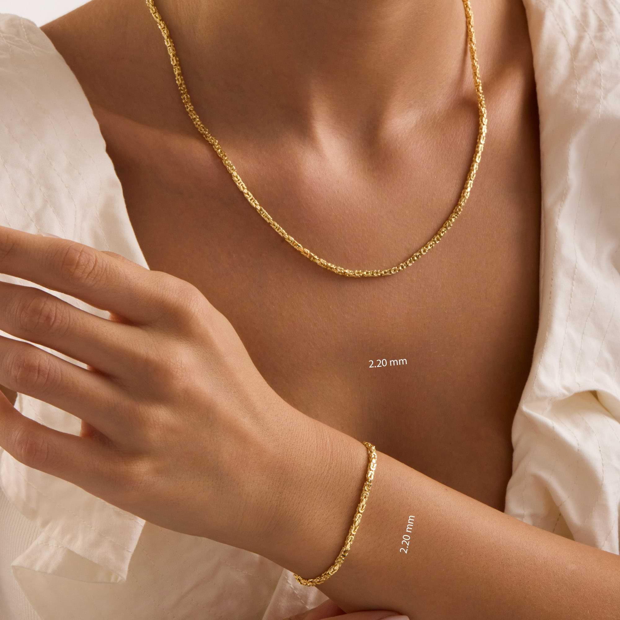 Gold 2.2mm byzantine necklace and bracelet on a lady's neck and wrist