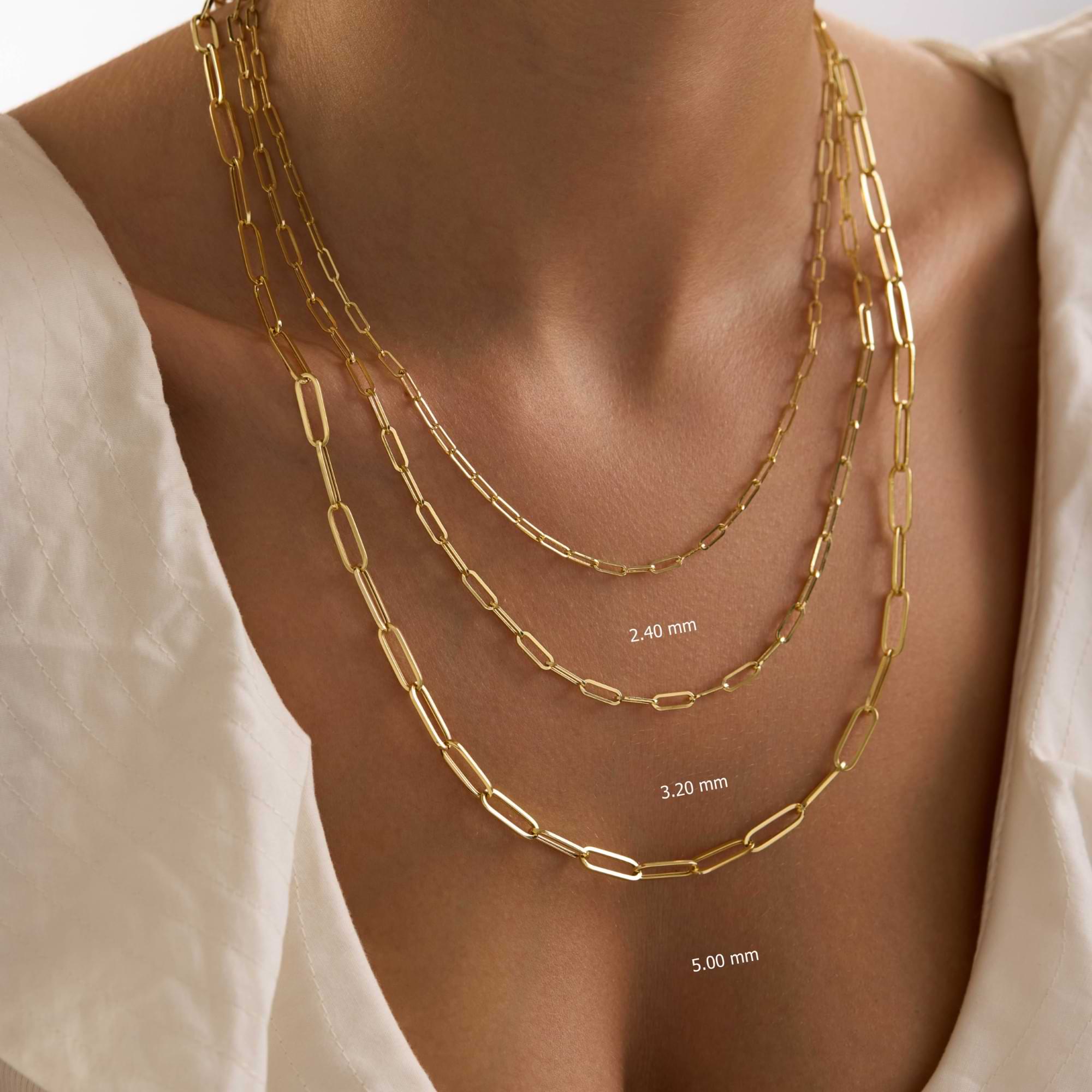 14k Gold paperclip chain necklaces of different widths on a person.