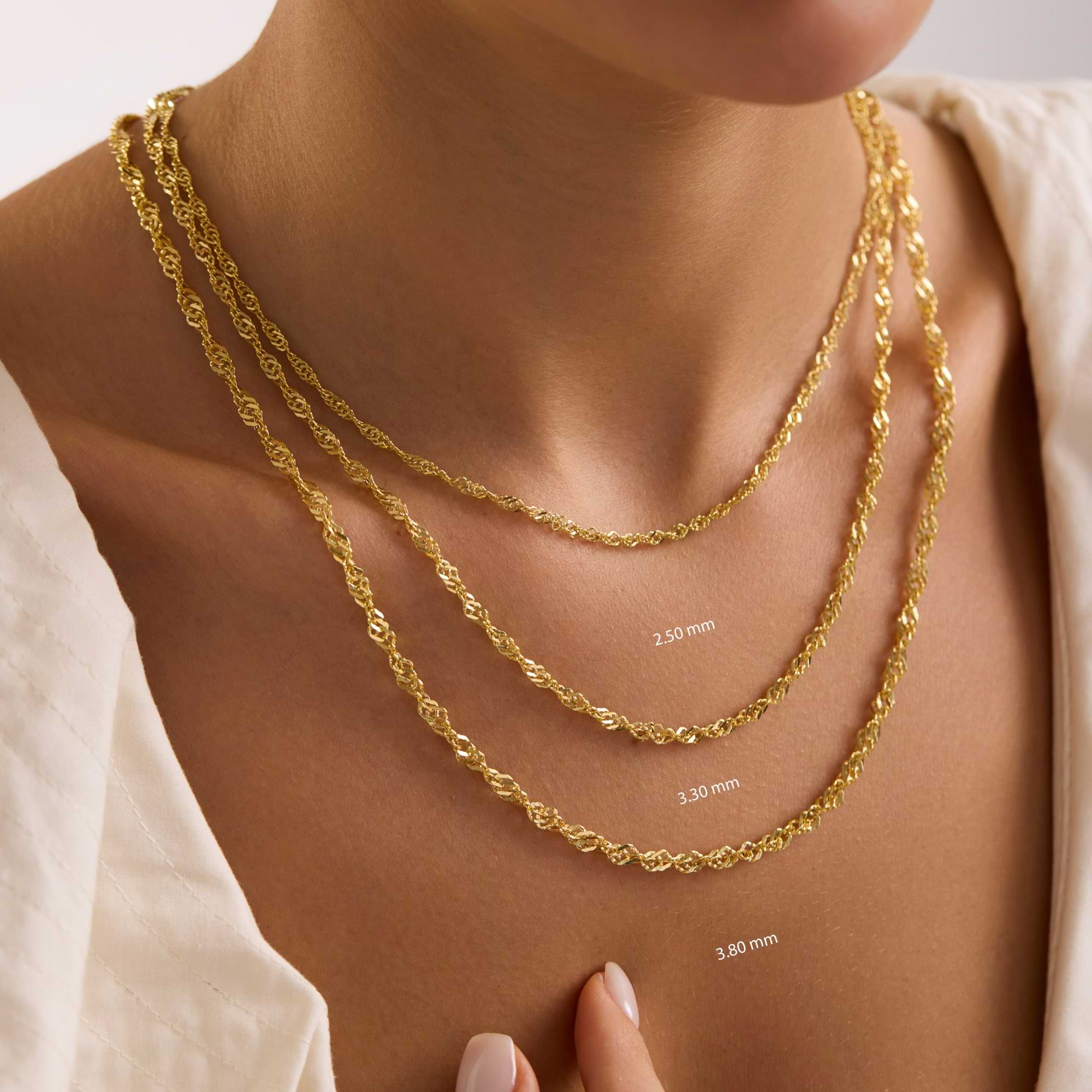 Gold Singapore chain necklaces of different thicknesses on a woman's neck with chain width measurements.